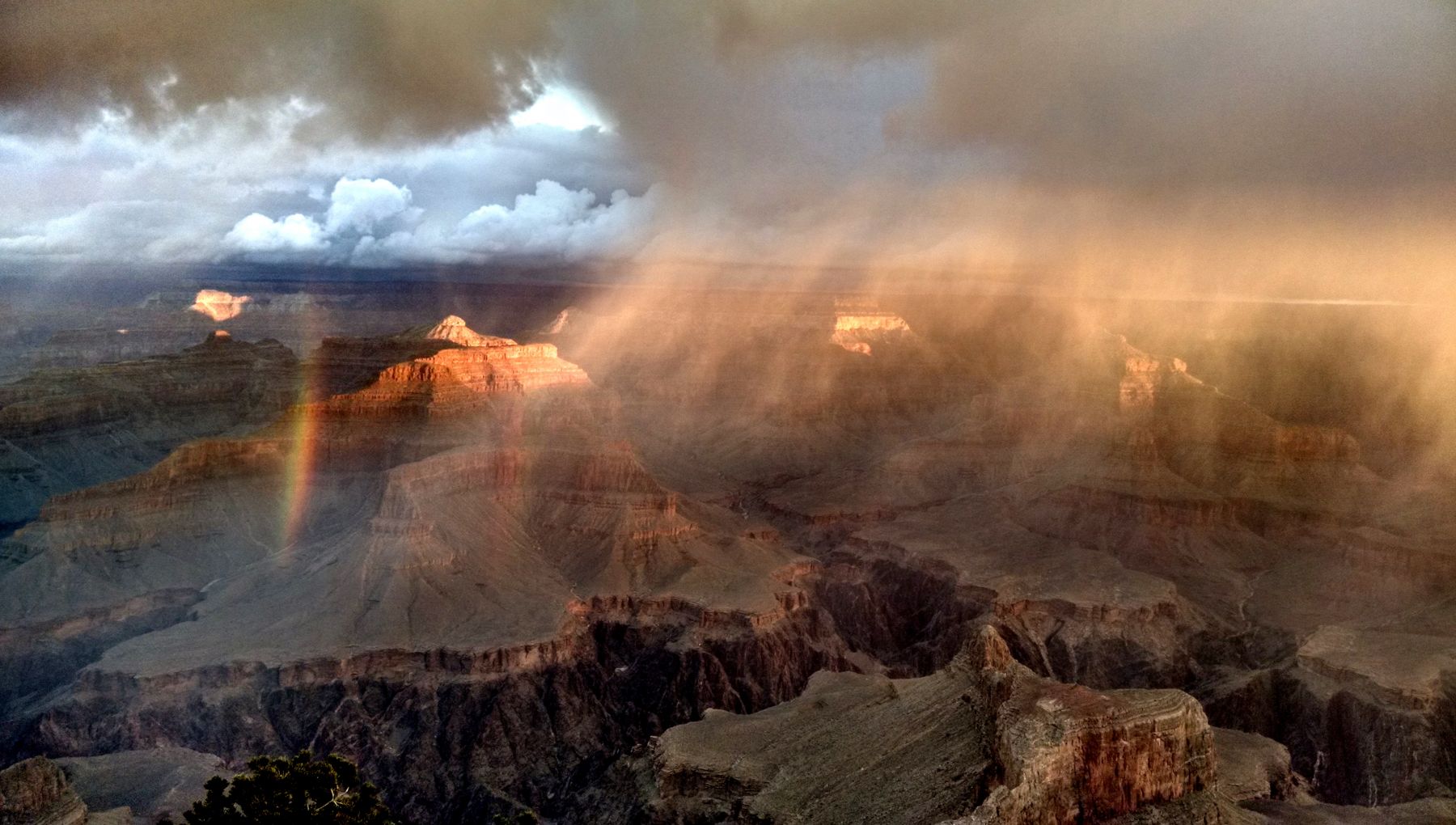 Grand Canyon on a rainy day with storm light, shifting clouds, and deeper canyon shadows
