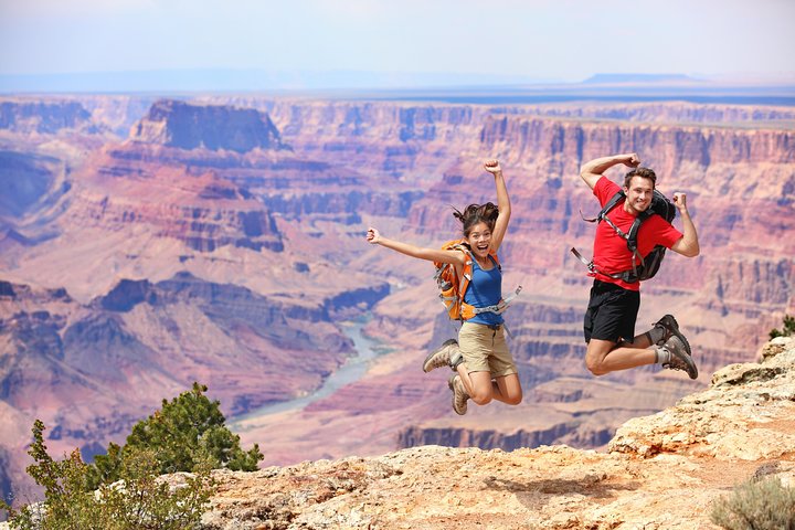 Grand Canyon small group tour with travelers taking in layered canyon views