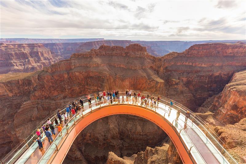 Grand Canyon West Rim bridge lookout with visitors at a scenic platform near Skywalk