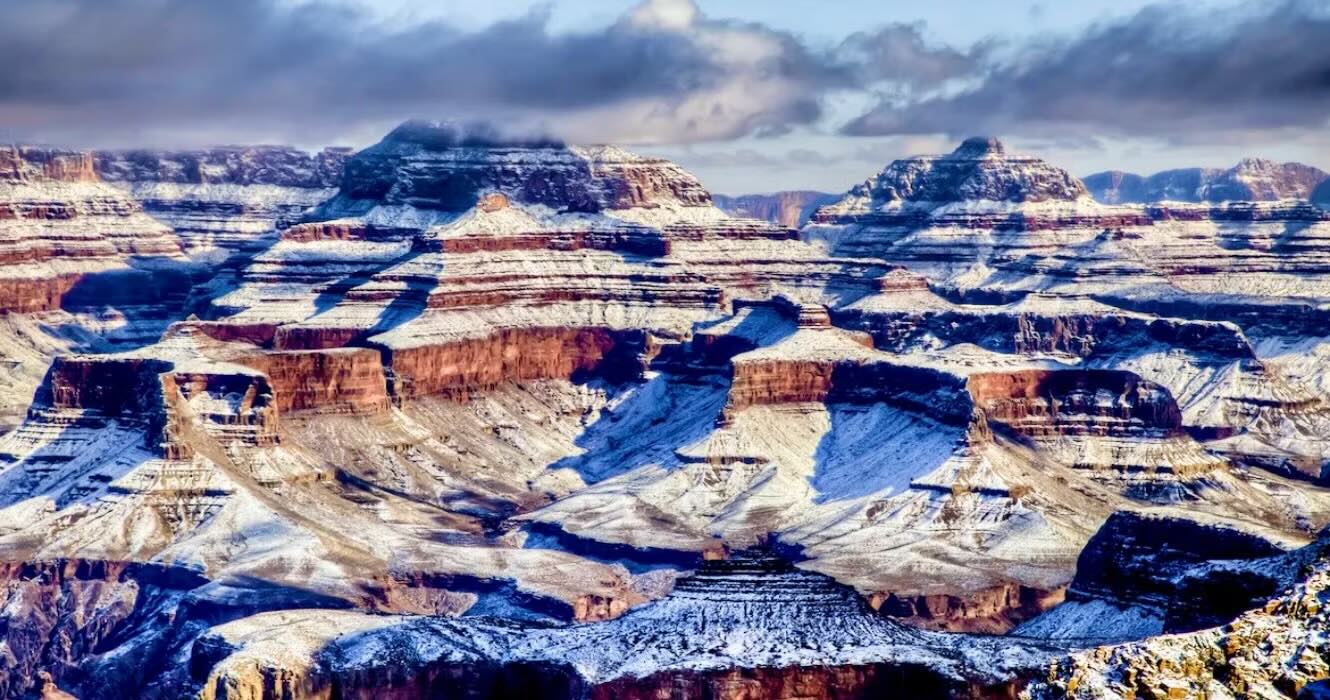 Grand Canyon in winter with snow along the rim and cold seasonal atmosphere